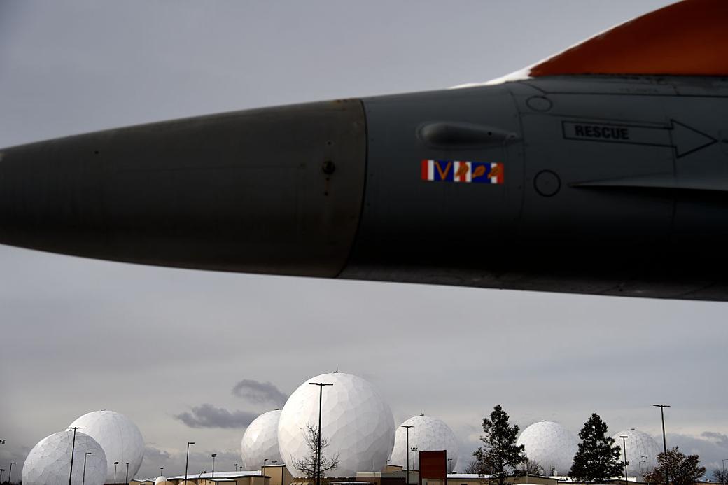 Buckley Space Force Base with plane in foreground and domes in background