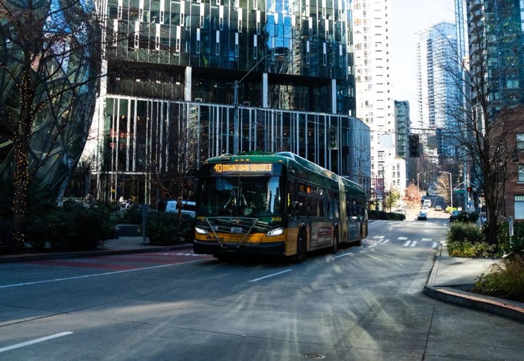 A King County Metro bus drives by downtown Amazon headquarters next to the spheres.