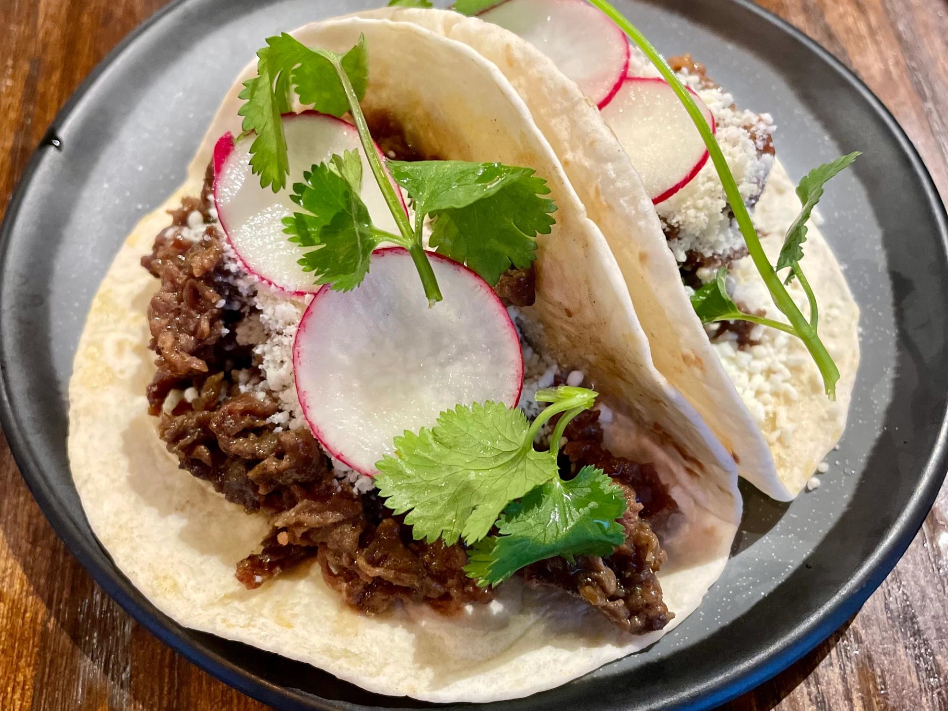 Two large Korean BBQ tacos with fresh radish and cilantro. (Marie Cecile Anderson / City Cast Nashville)