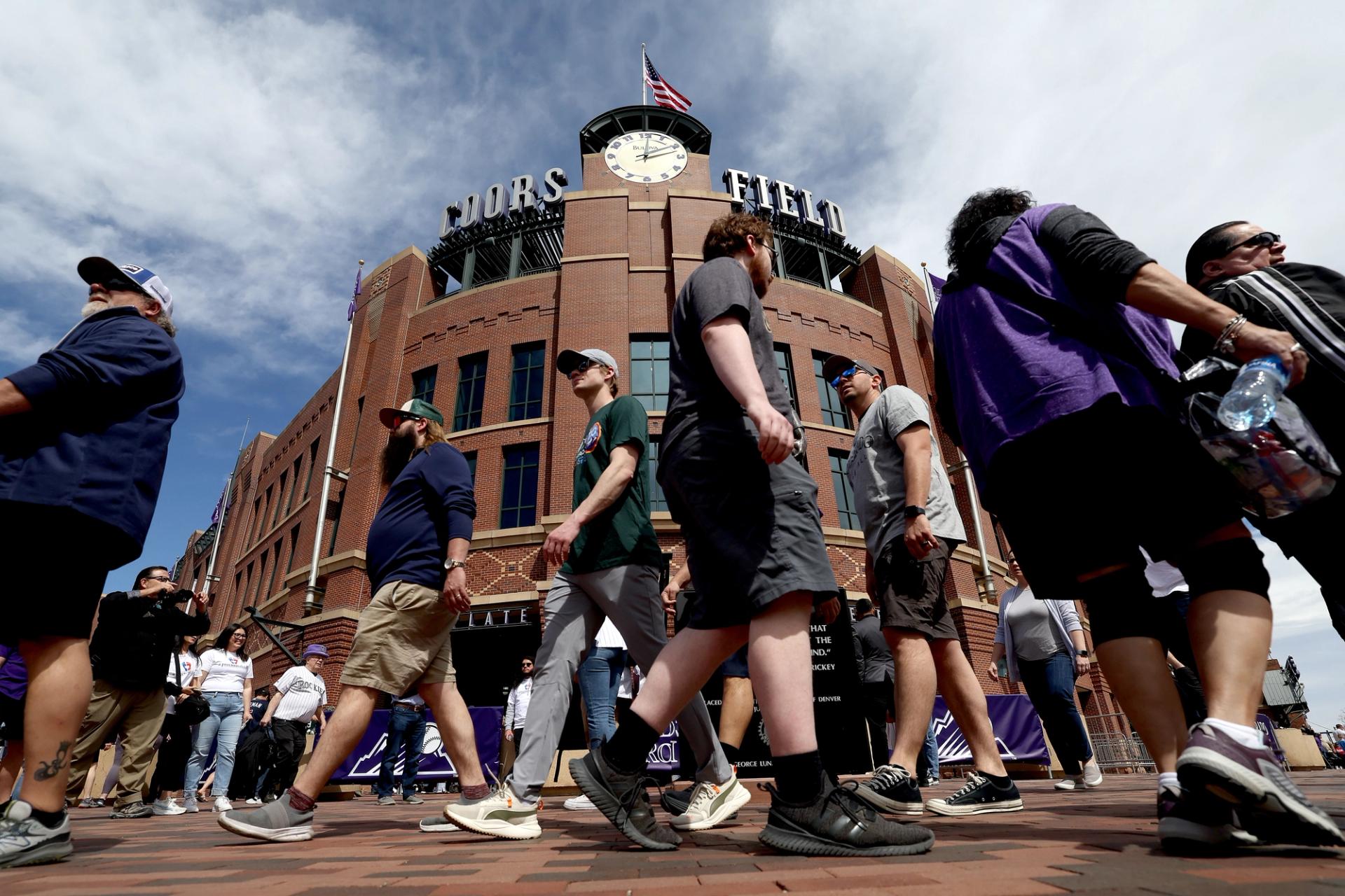Baseball fans walk outside of Coors Field at the 2024 opening day game.