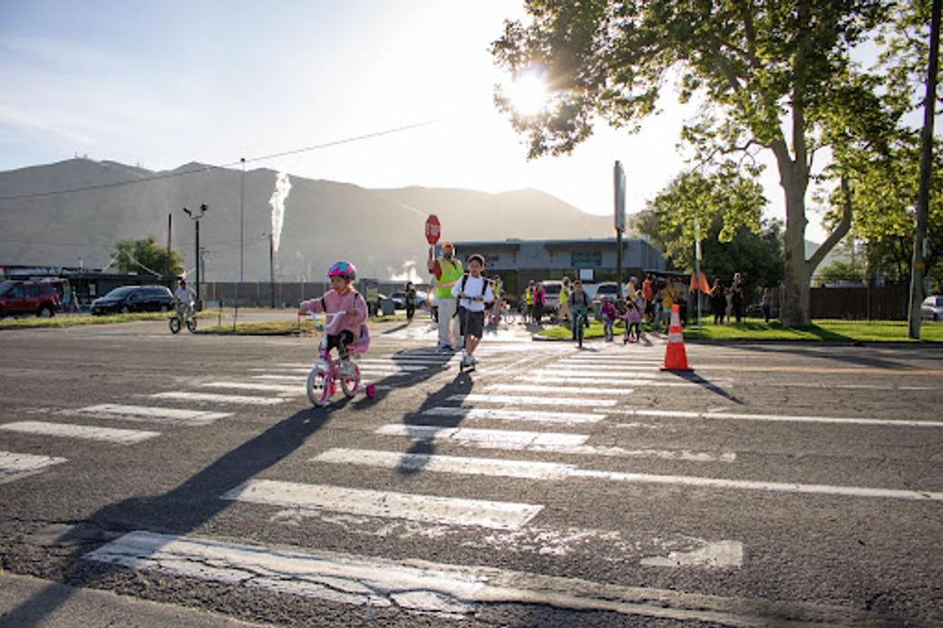 Children bike across a crosswalk. 