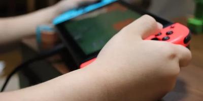 Image of someone holding a Nintendo Switch