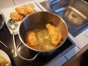 empanadas being deep fried