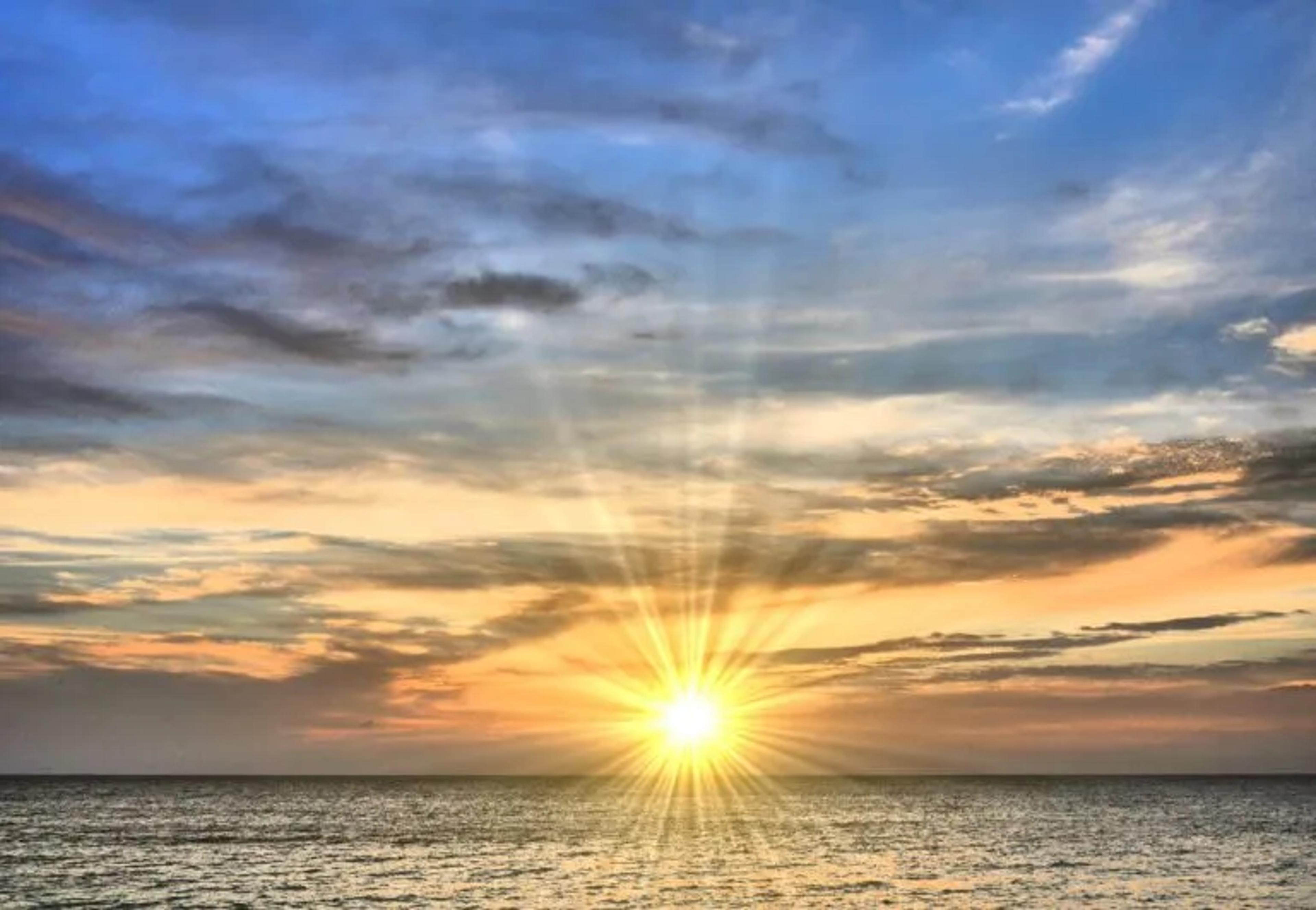 image of the sun over water