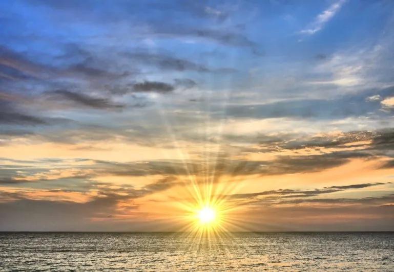 image of the sun over water