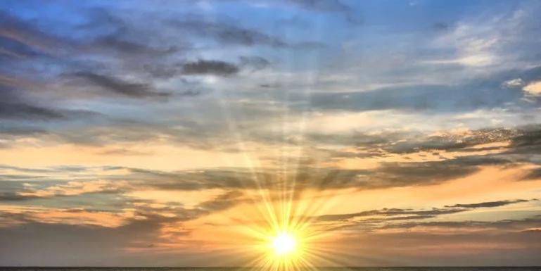 image of the sun over water