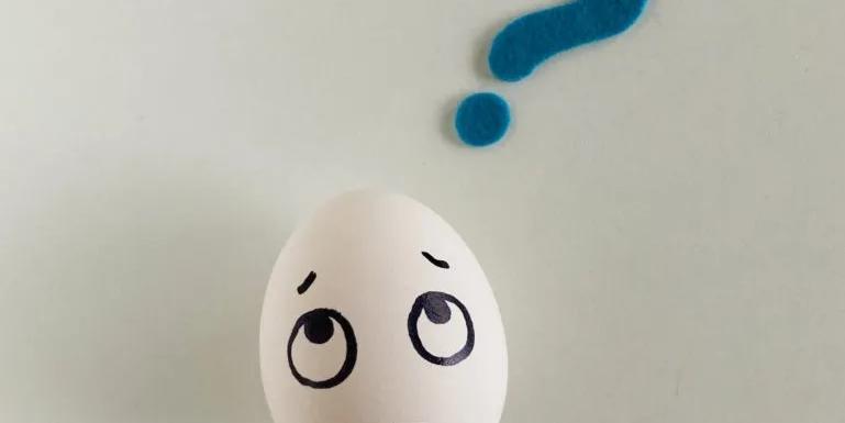 An Egg with a confused face drawn on it with a blue quesion mark above