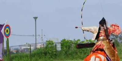 man on a horse with a bow aiming at a target