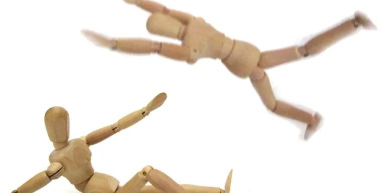 Wood man jumping at another woodman