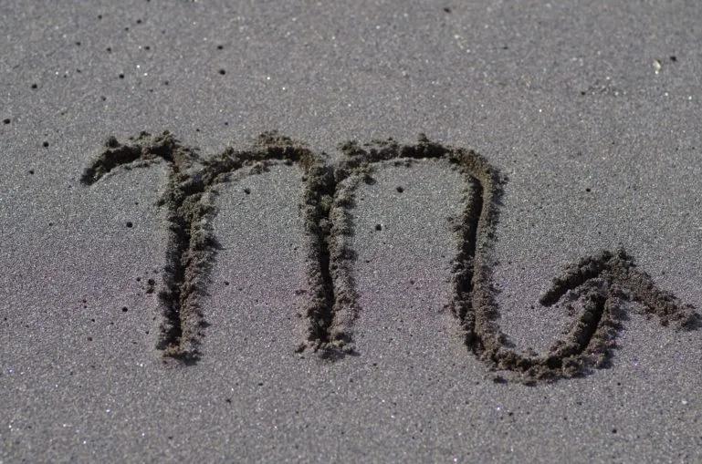 Image of the Scorpio sign writen in sand