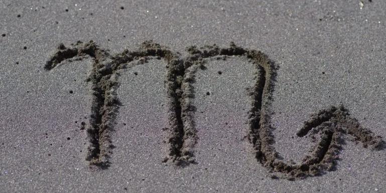 Image of the Scorpio sign writen in sand