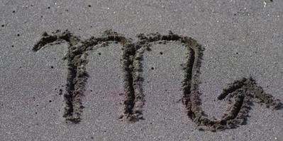 Image of the Scorpio sign writen in sand