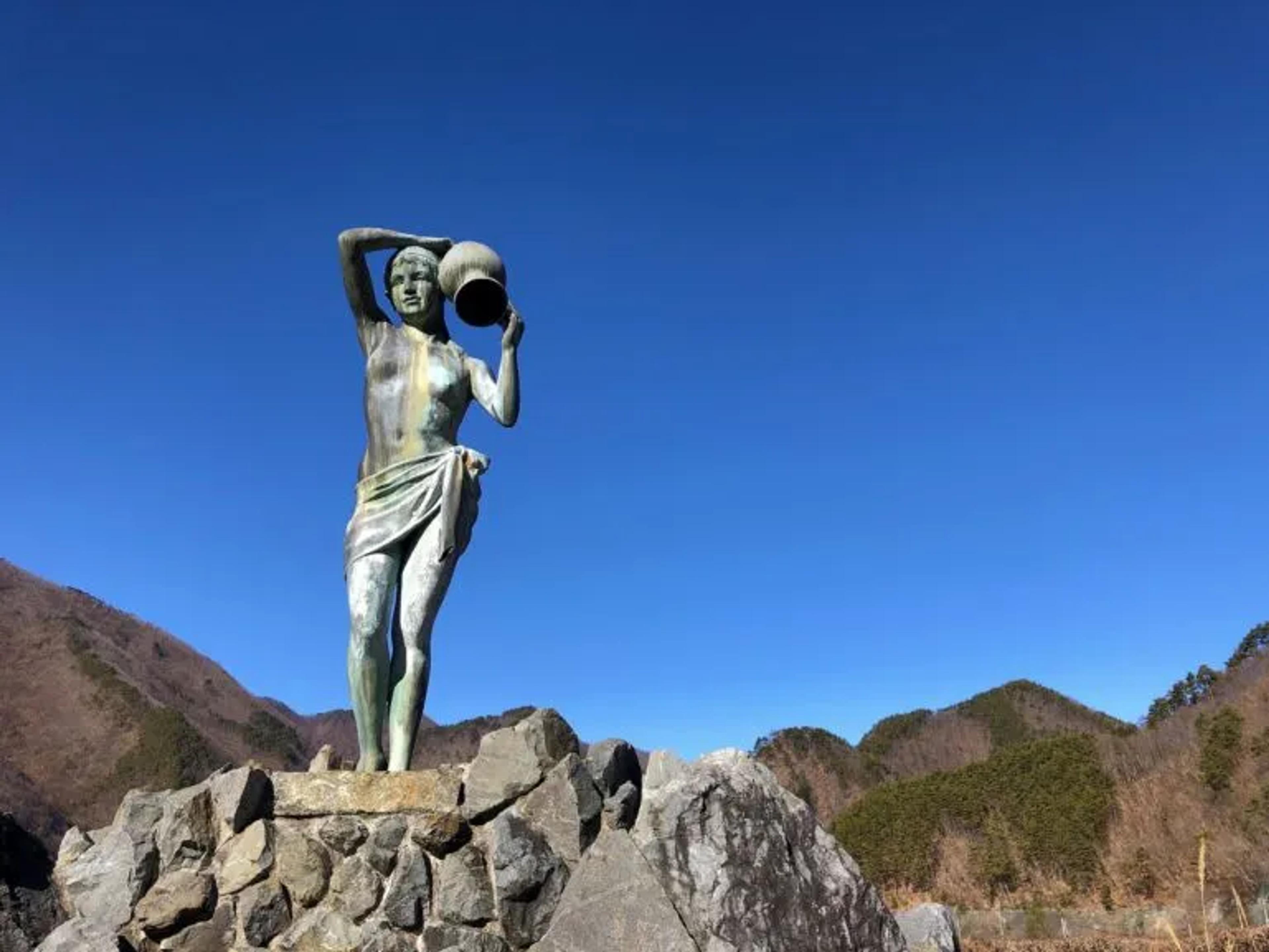 Statue of a Woman holding a pot