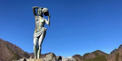 Statue of a Woman holding a pot