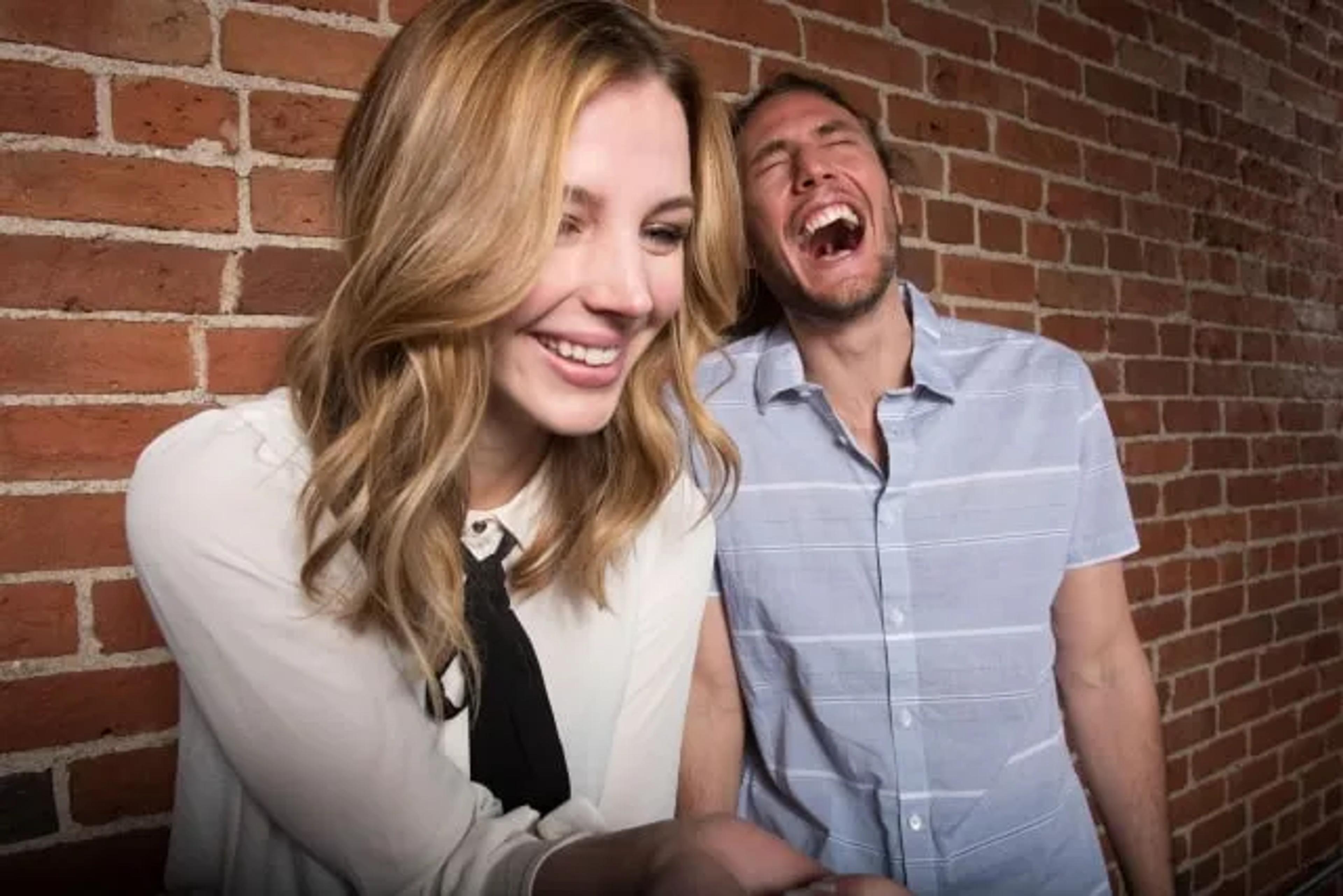 people laughing in front of a computer