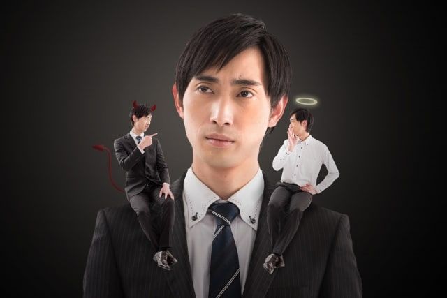 Man and a devil and an angel on his shoulder