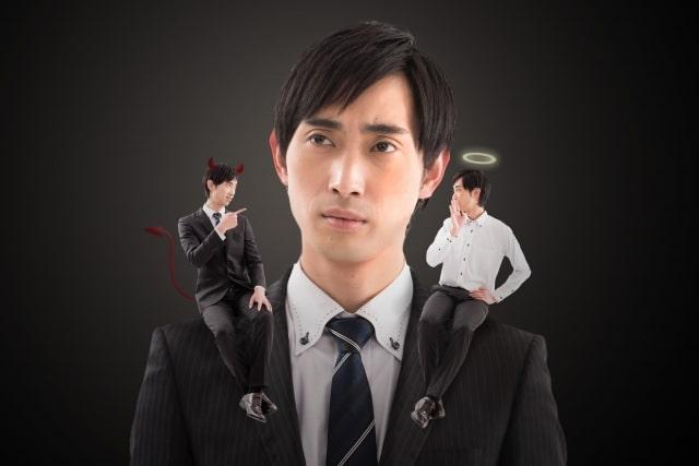 Man and a devil and an angel on his shoulder