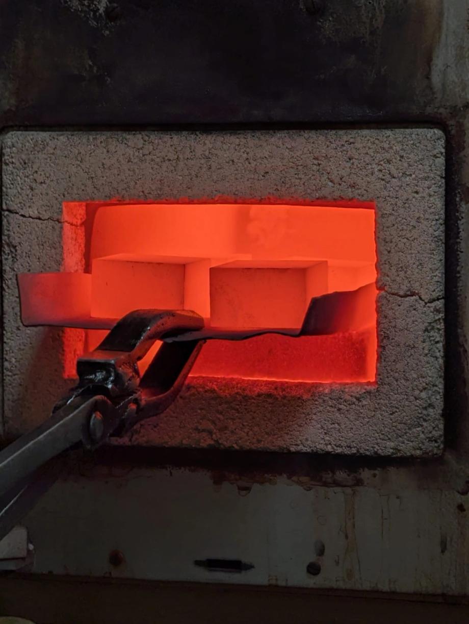 Red-hot part during heat treatment. In our workshop we carry out hardening, carburising and tempering.