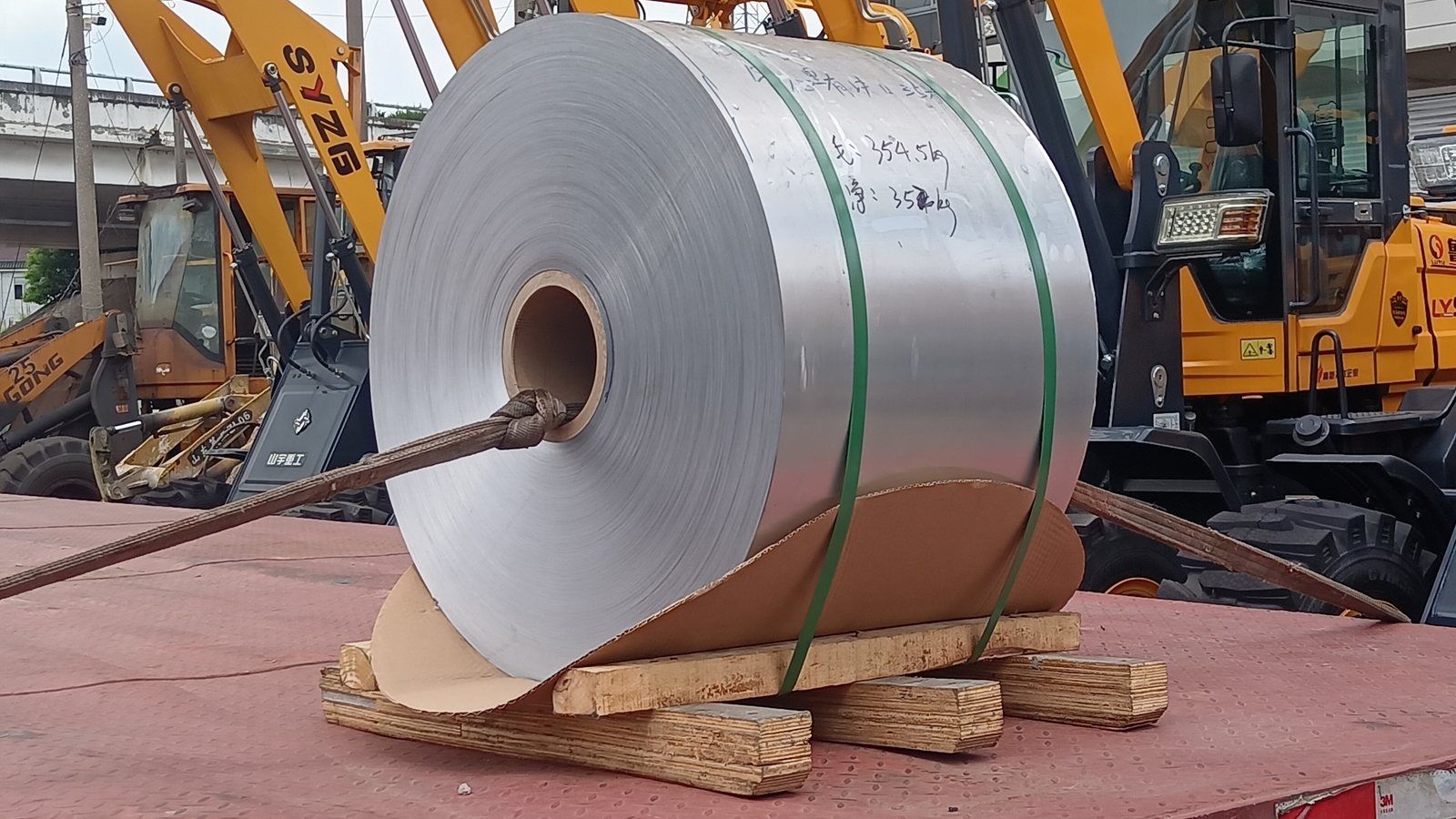 A steel coil strapped to a truck deck