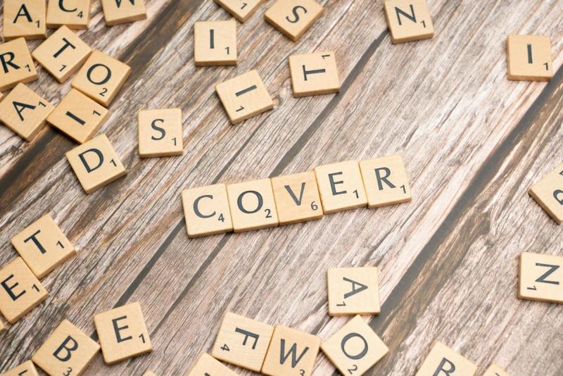 close-up of a neatly formatted cover letter with a pen and notebook