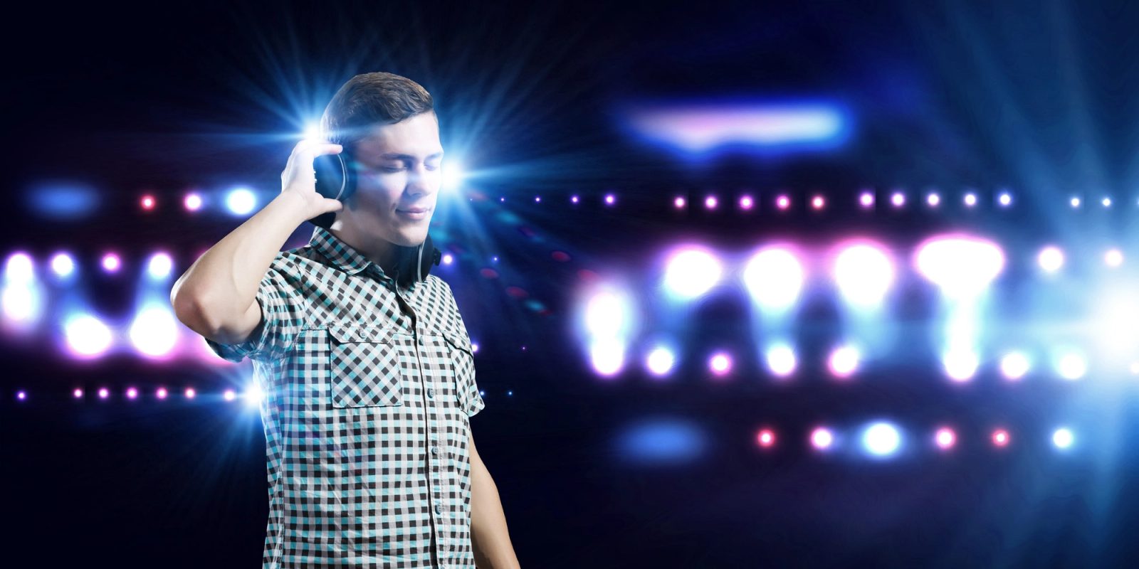 man wearing headphones at a concert
