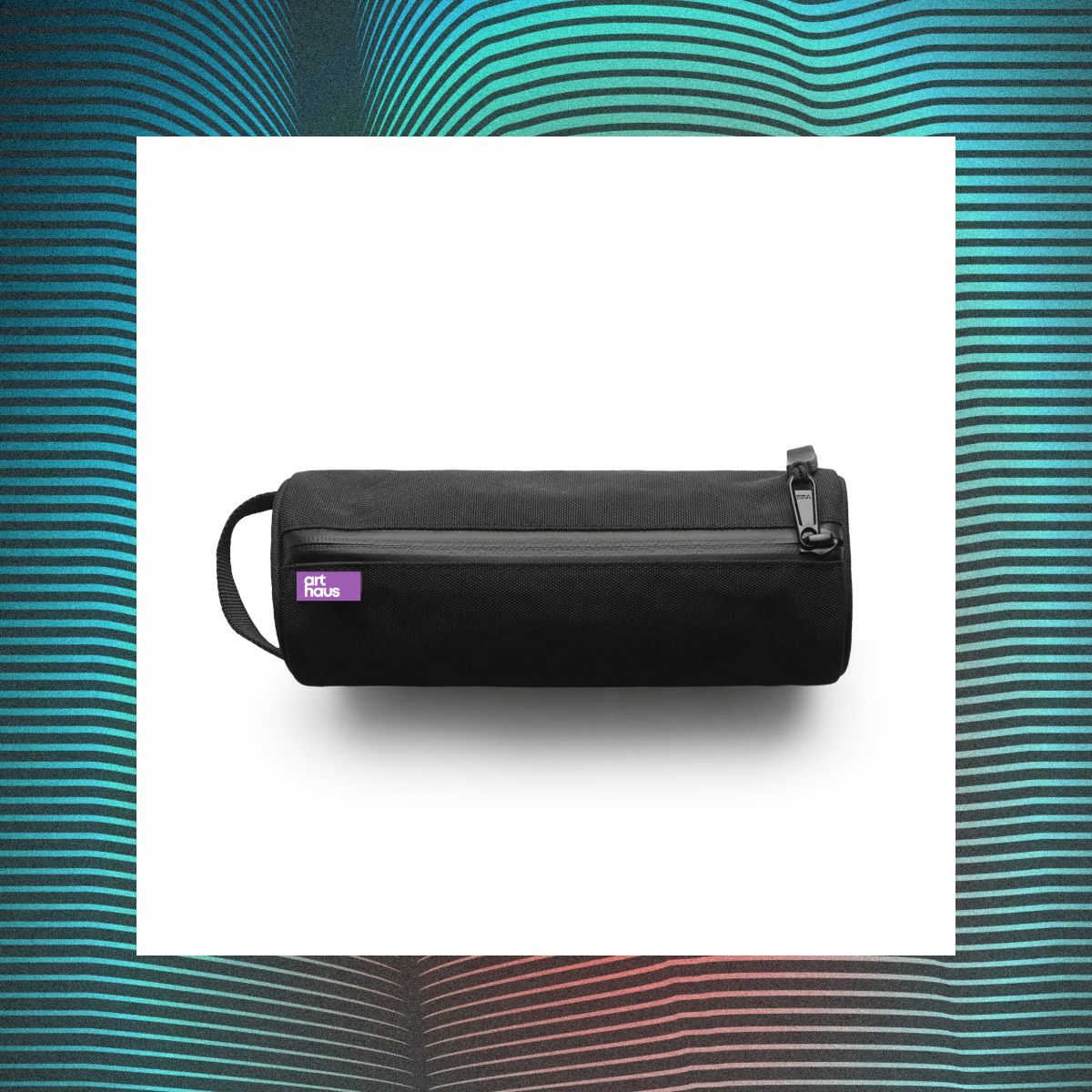 Black Art Haus utility pouch with purple wordmark label, photographed on a multicolor graphic backdrop.