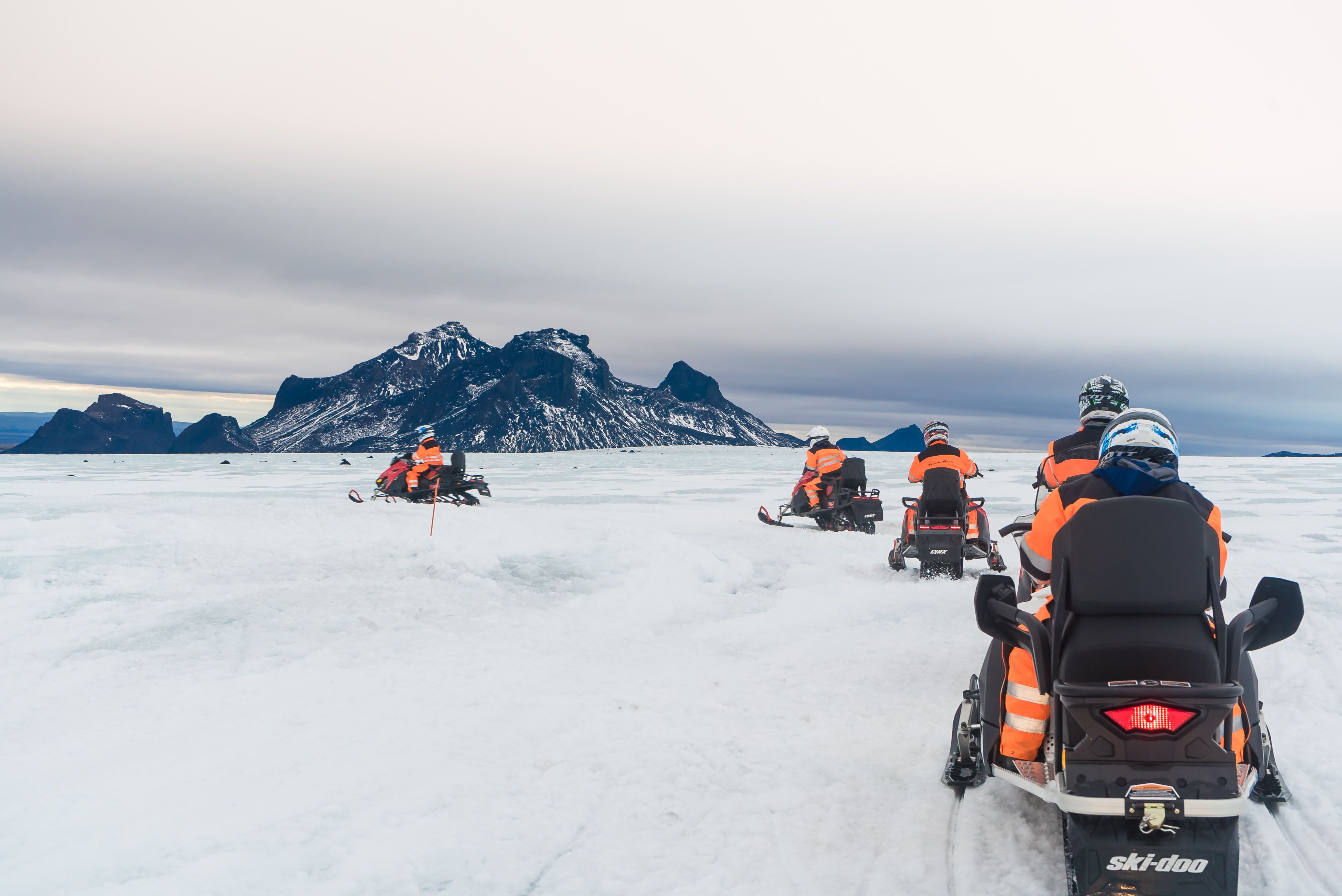 guests exploring langjökull glacier on snowmobile