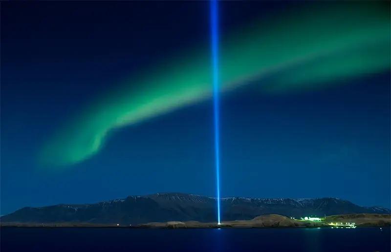 northern lights over the imagine peace tower