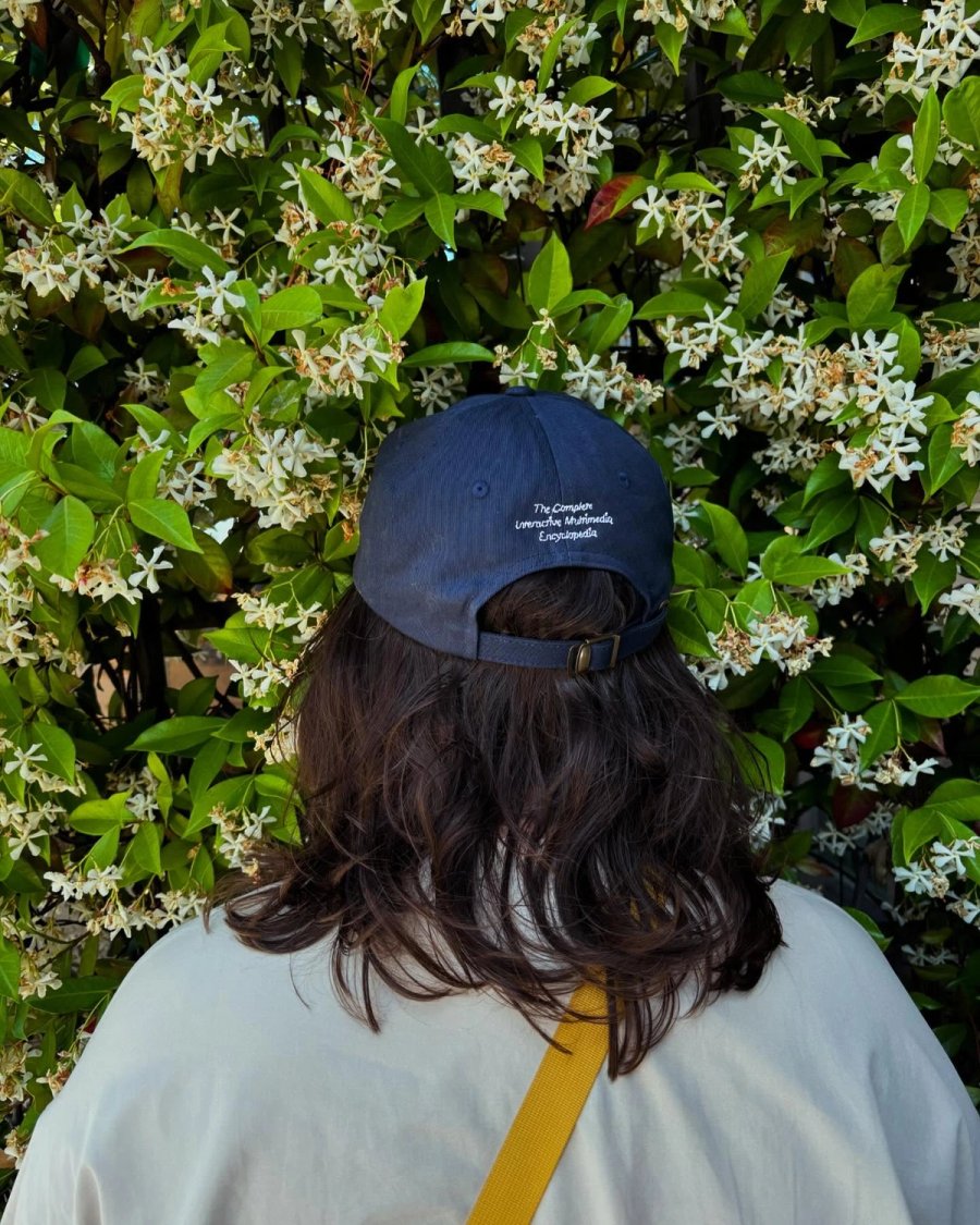 A person facing into a jasmine bush