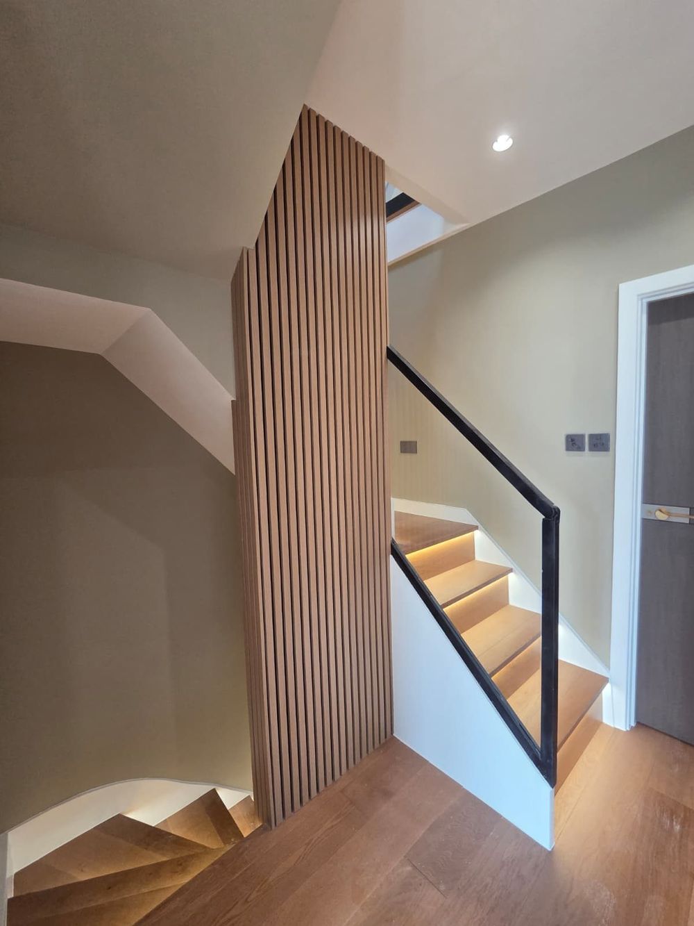Slatted wood feature with glass balustrade — Full House Renovation by TrustBuilt Projects