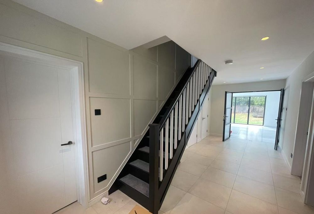Finished hallway — panelled staircase and tiling — Hallway Transform by TrustBuilt Projects