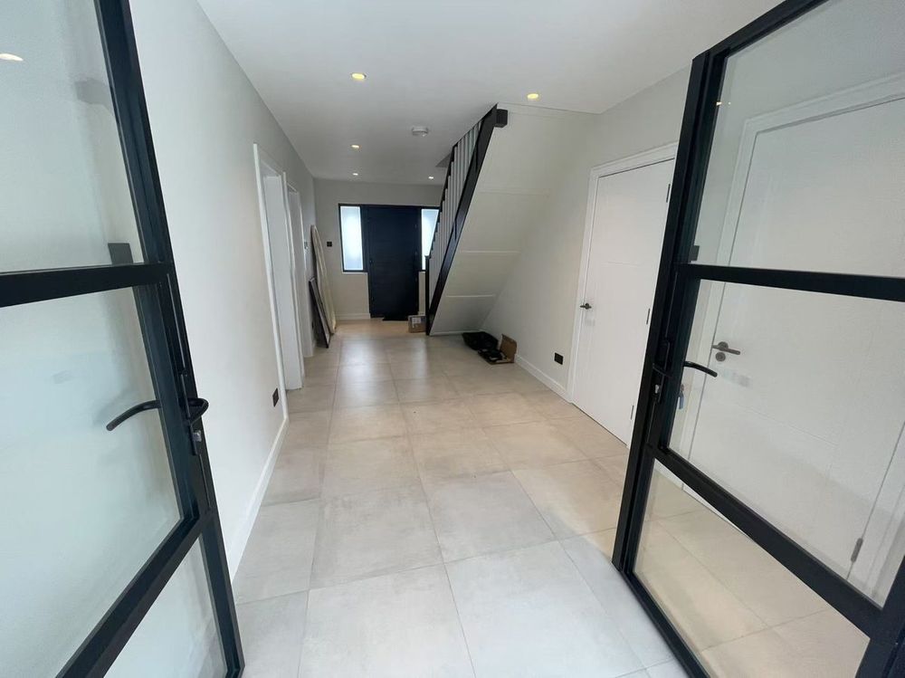 View through Crittall-style glass doors — Hallway Transform by TrustBuilt Projects