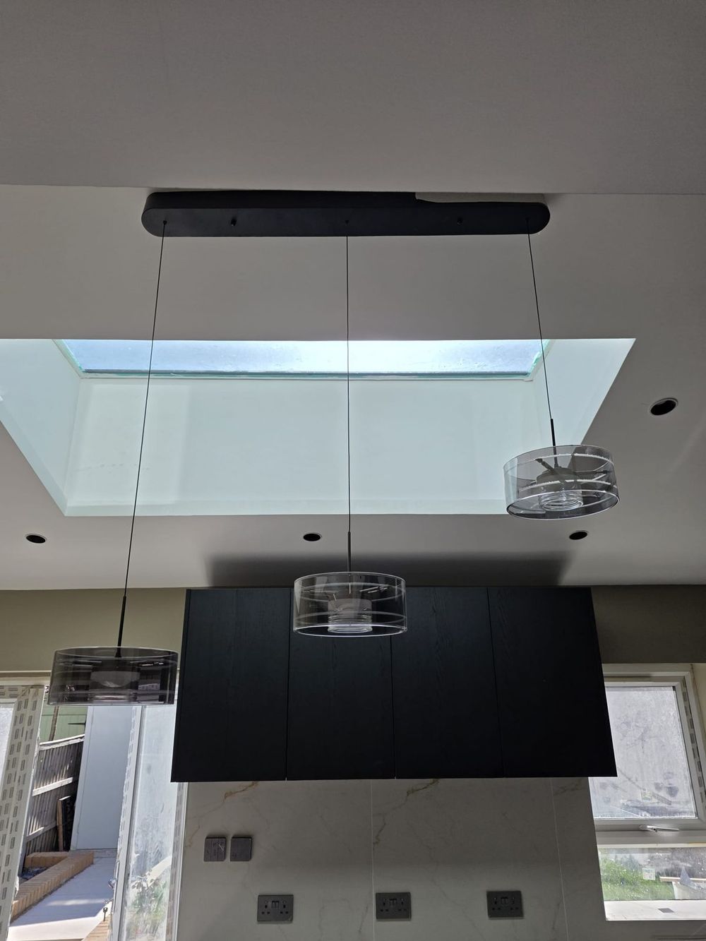 Skylight with designer pendant lights — Full House Renovation by TrustBuilt Projects
