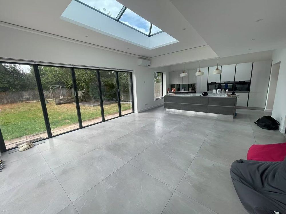Open-plan interior with skylight and bi-fold doors — Rear Extension by TrustBuilt Projects