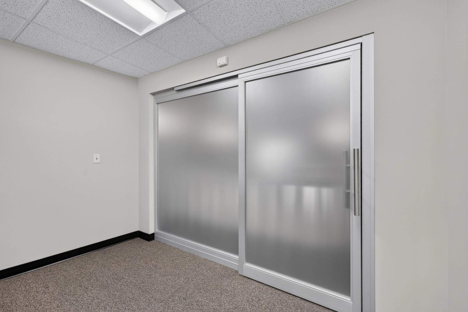 Two panel ThinWall sliding door with frosted glass in a clear anodized aluminum frame, closed