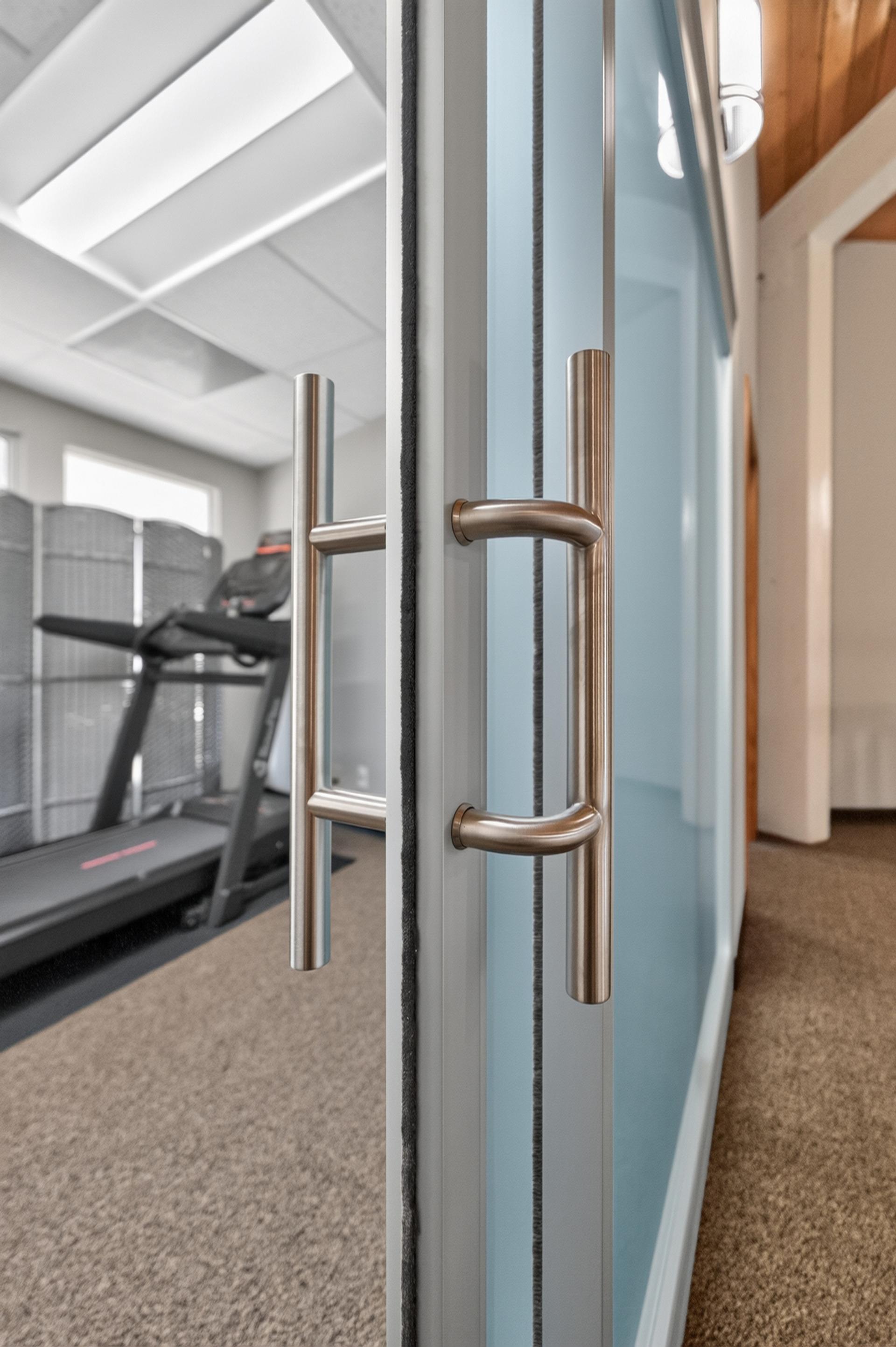 Back to back ladder pulls on a frosted glass ThinWall sliding door