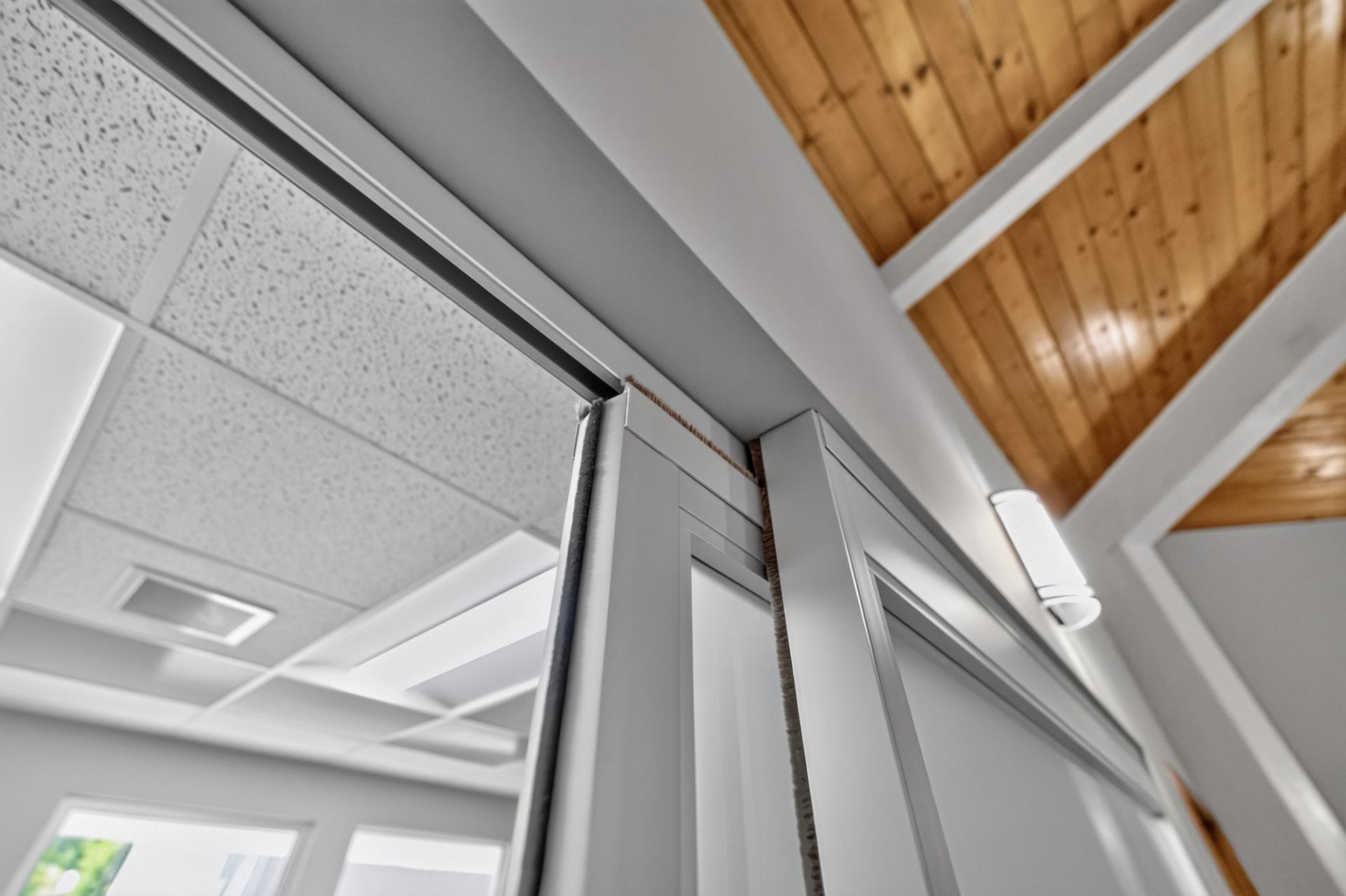 ThinWall sliding door head and frame meeting the ceiling
