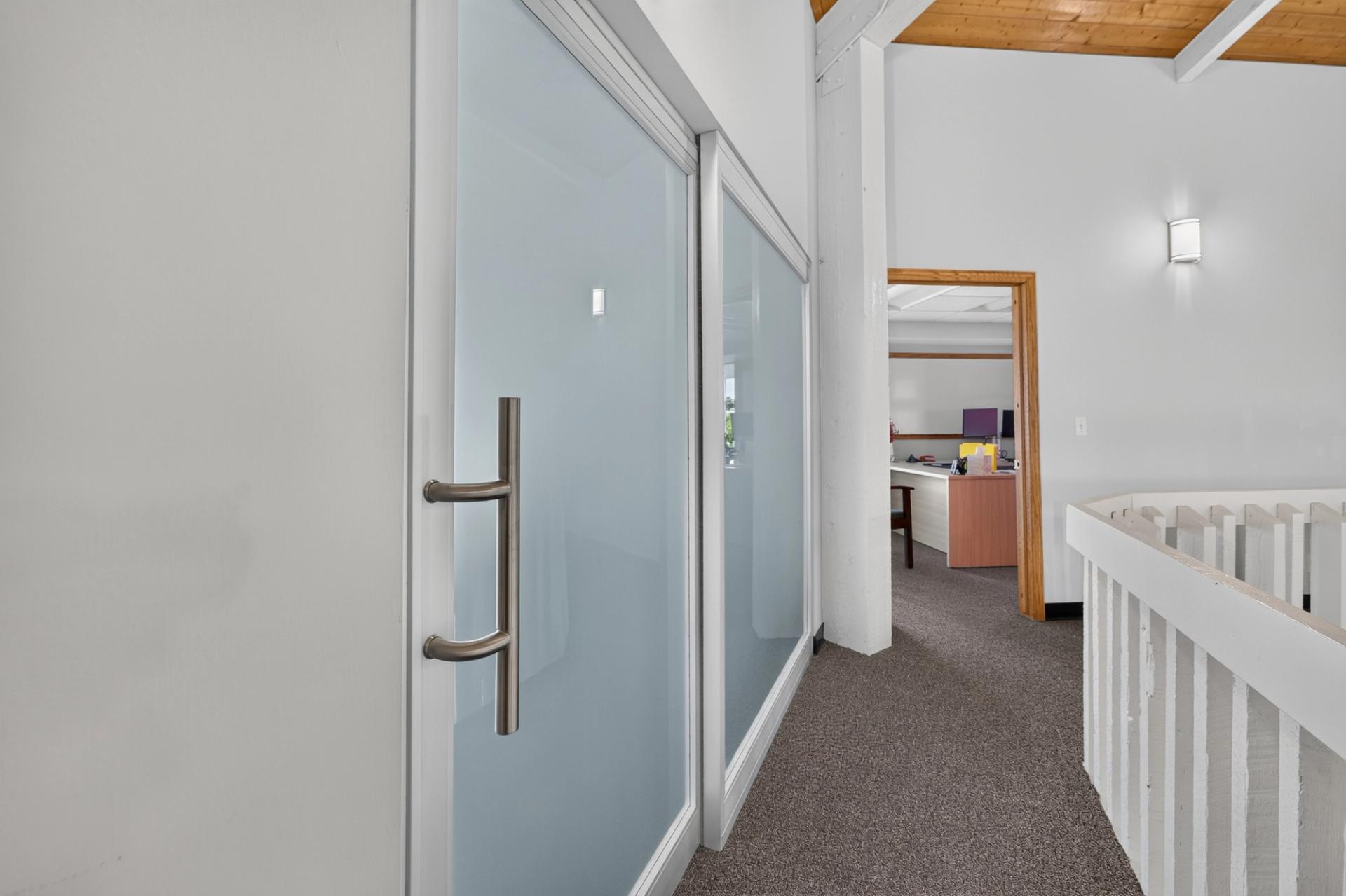 Frosted glass ThinWall sliding door closed along the landing