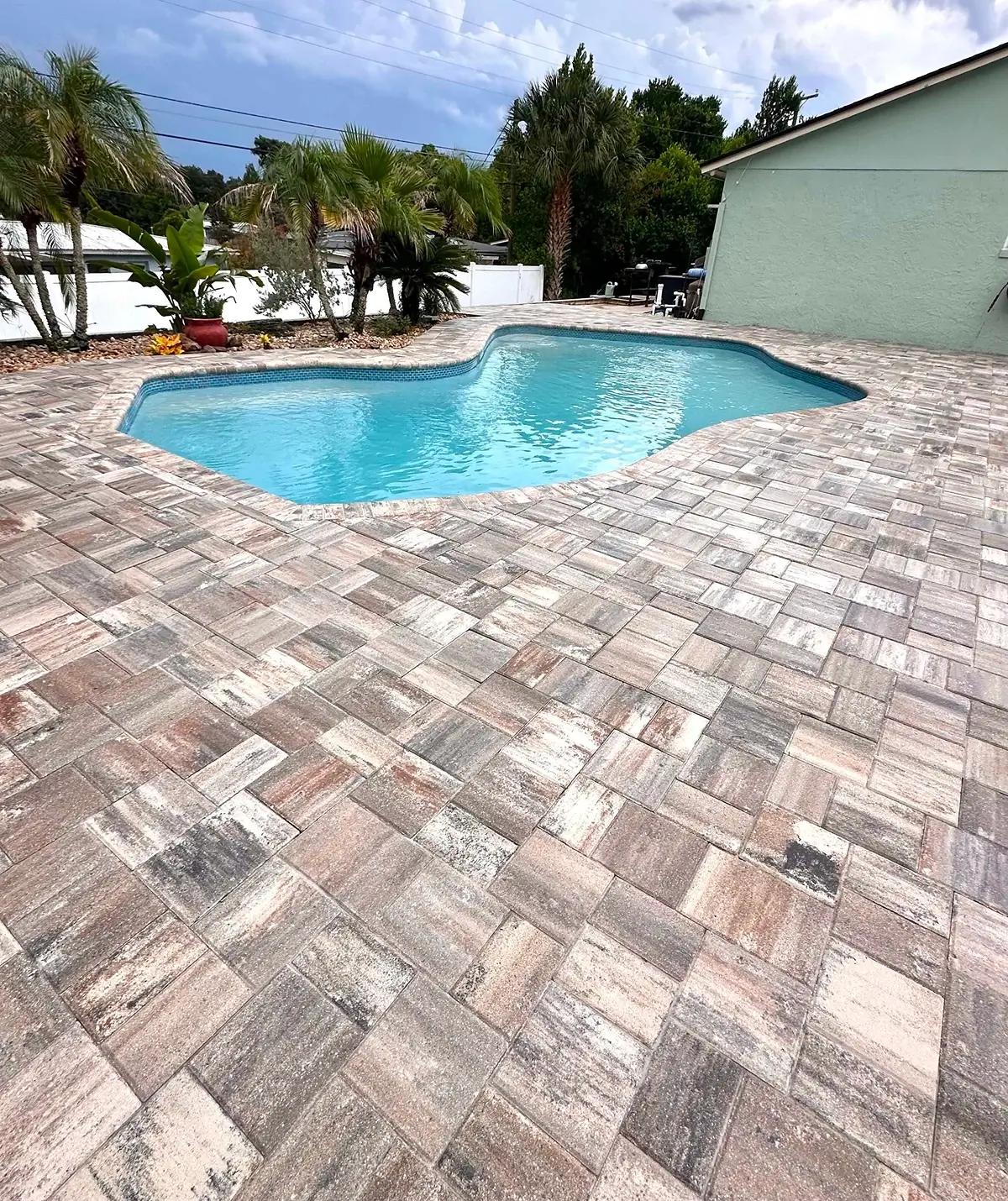 Brick paver pool deck surrounding a residential swimming pool in Orlando, FL