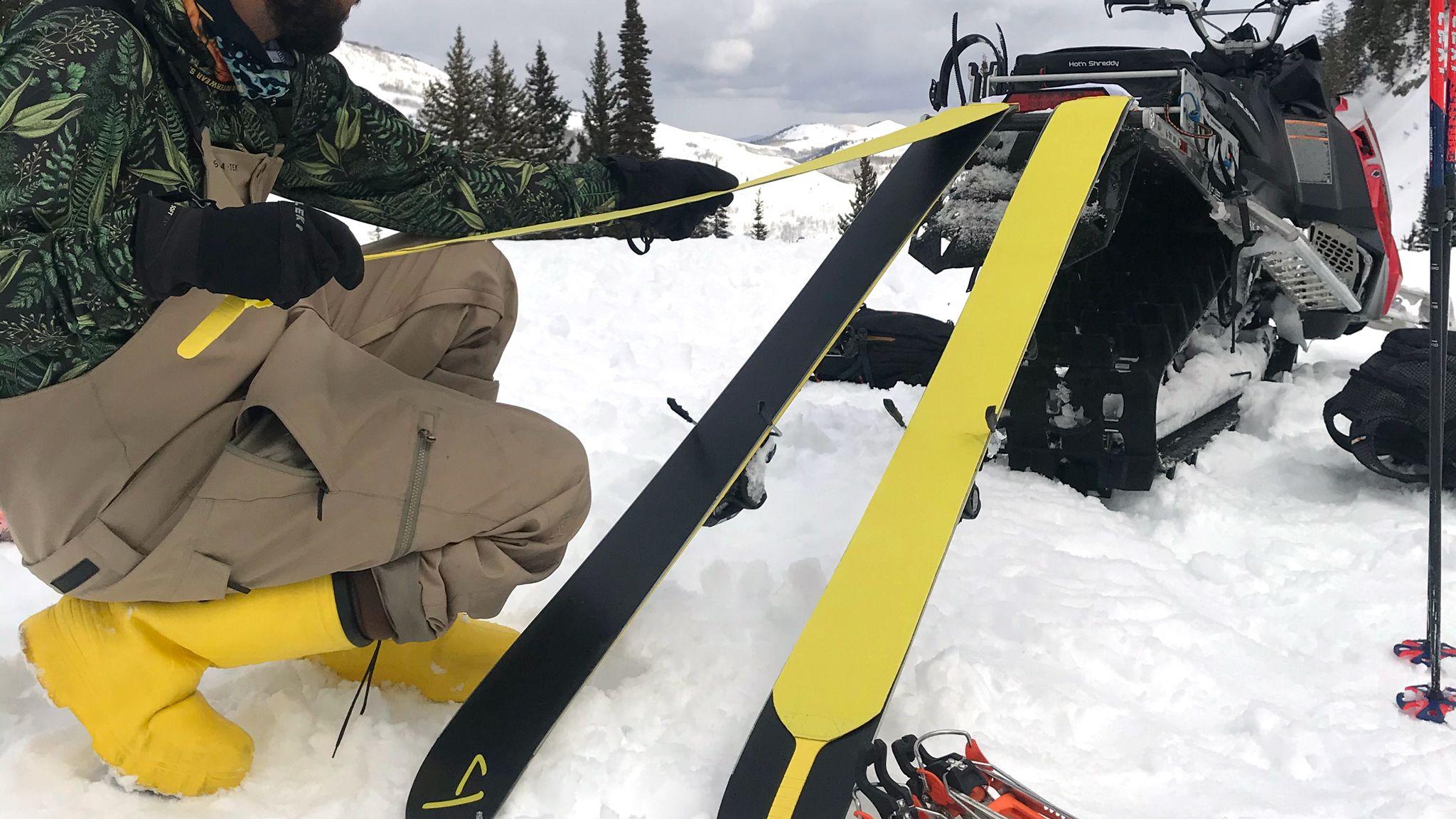 Skier Giray Dadali putting pre-cut pomoca skins on his J skis Slacker in the backcountry