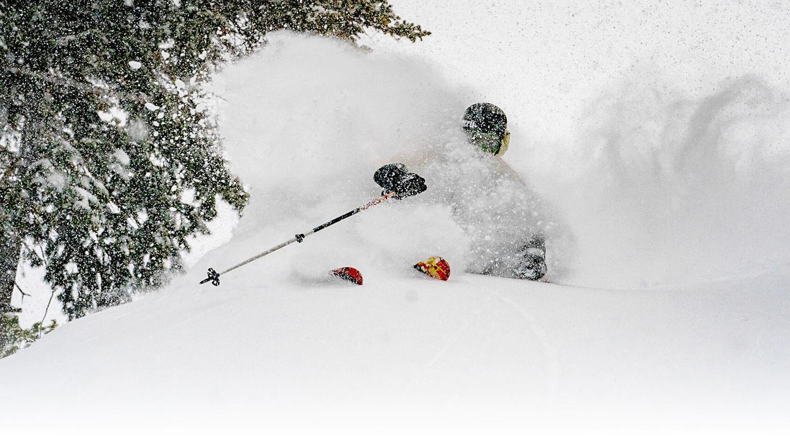 J skier shredding super deep powder on explore collection friend ski