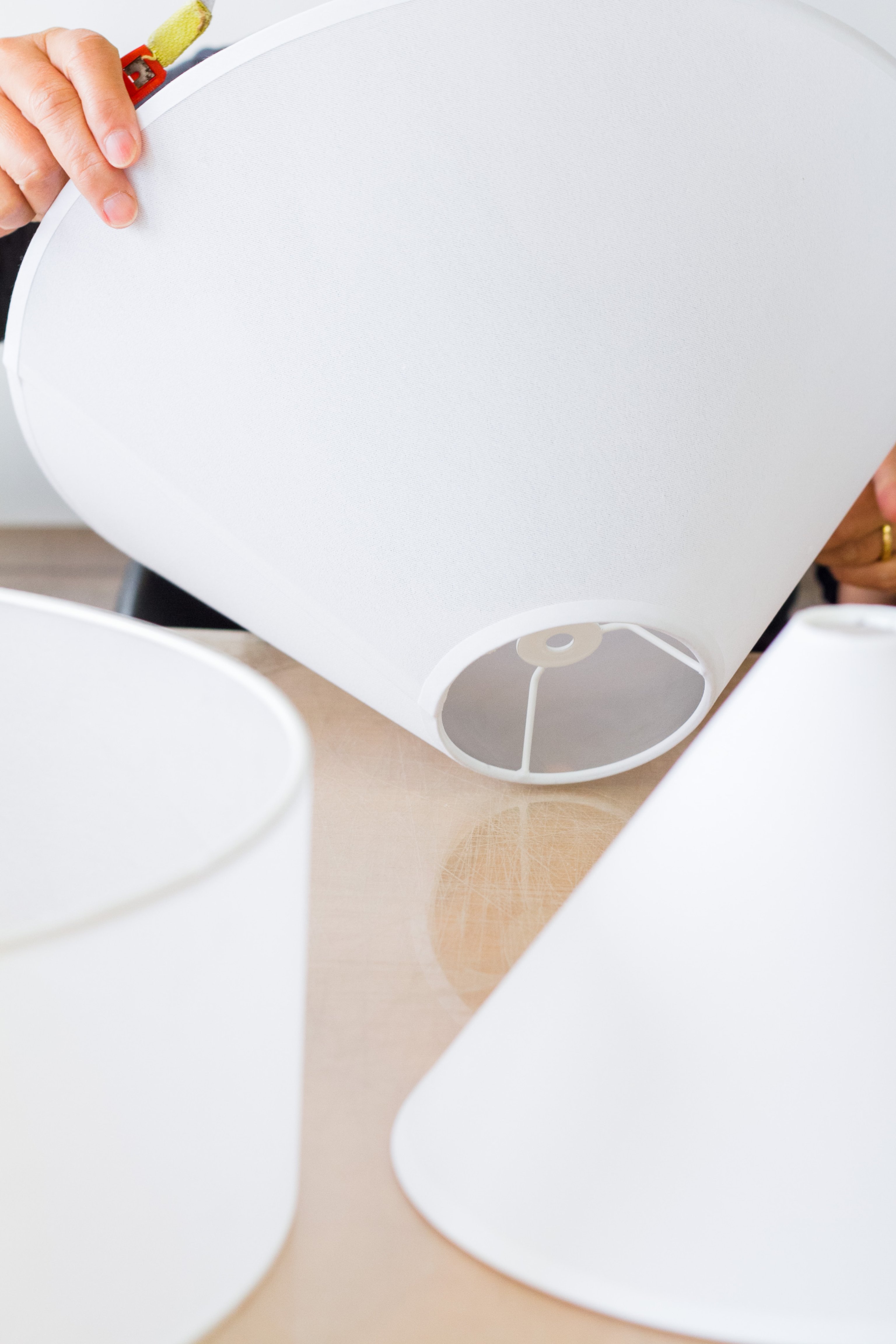White fabric shades being made my hand