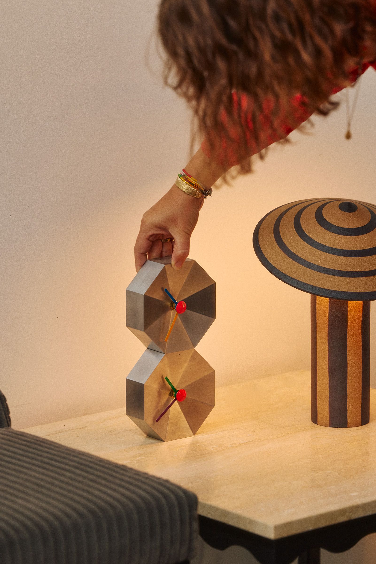 Two stacked Mill Clocks next to a Dancer Table Light in the Coco Flip showroom