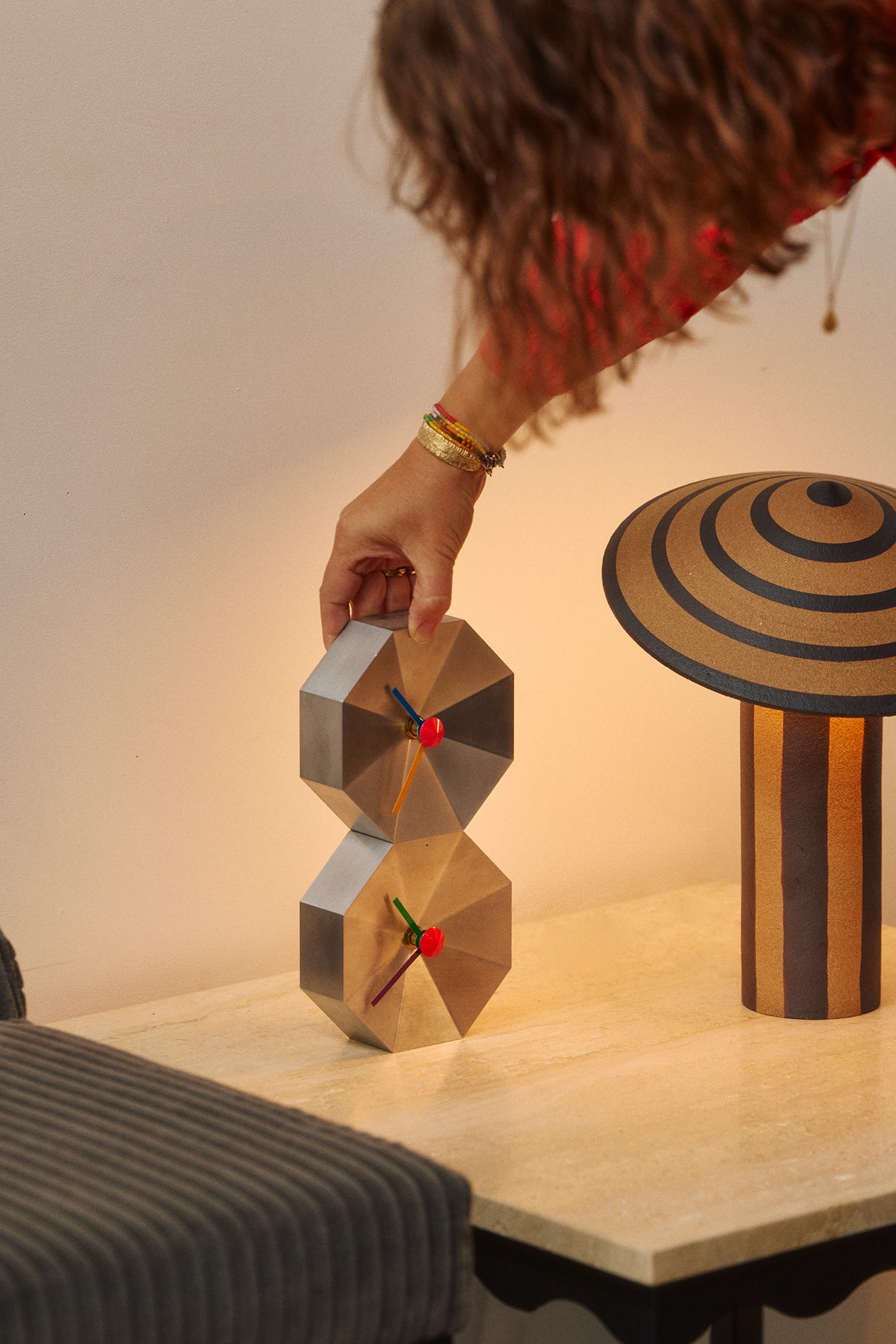 Two stacked Mill Clocks next to a Dancer Table Light in the Coco Flip showroom
