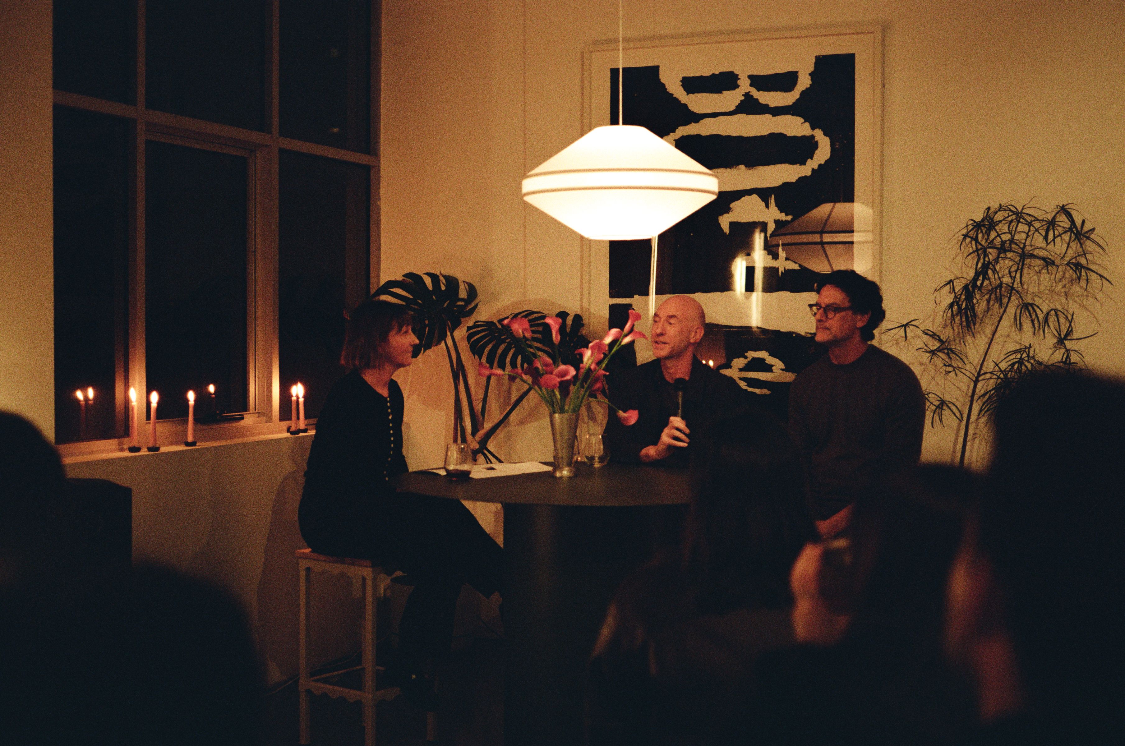 People gathered around a table for a conversation.