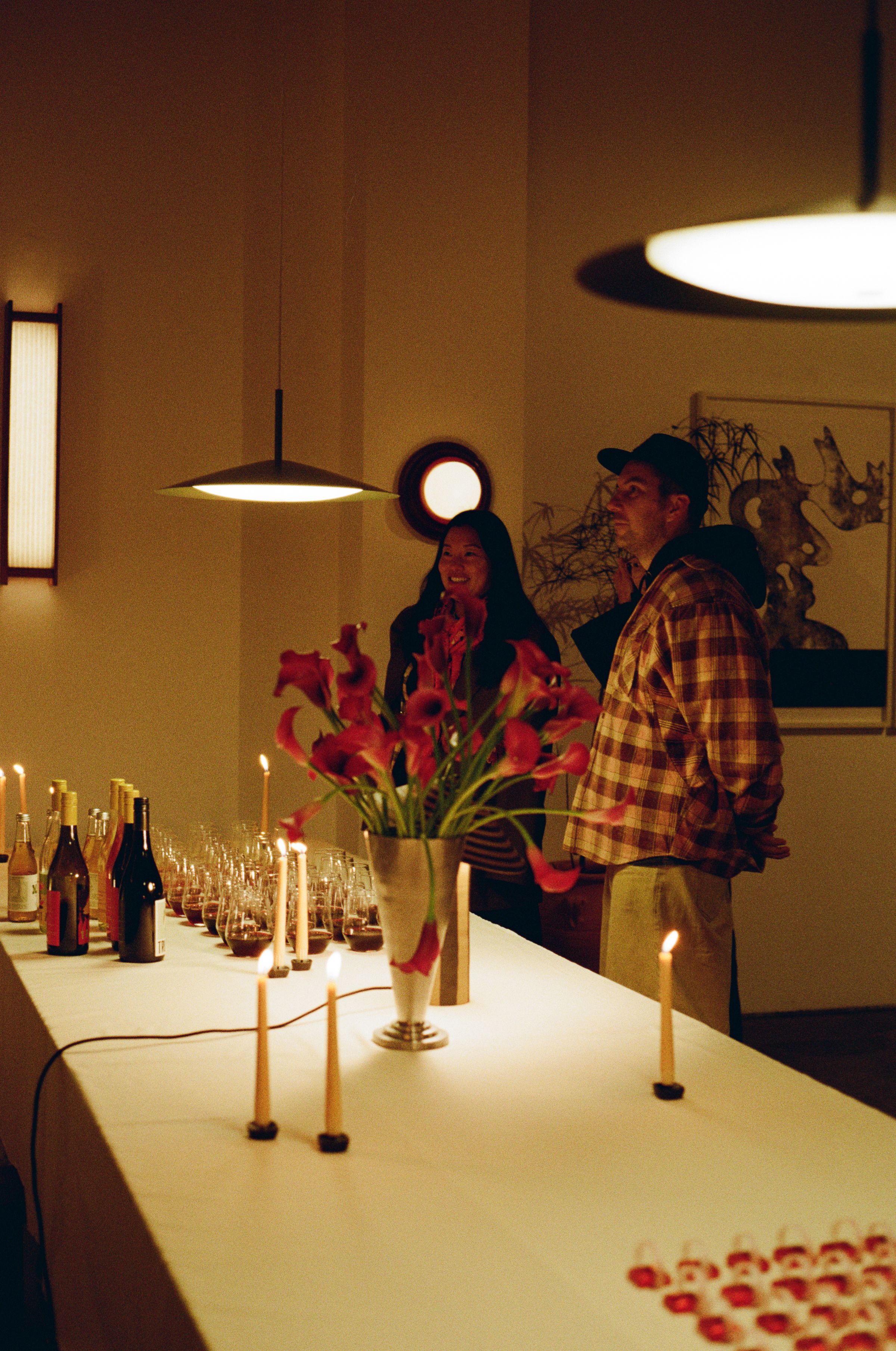 People gathered at the drinks table to enjoy conversation and order a drink.