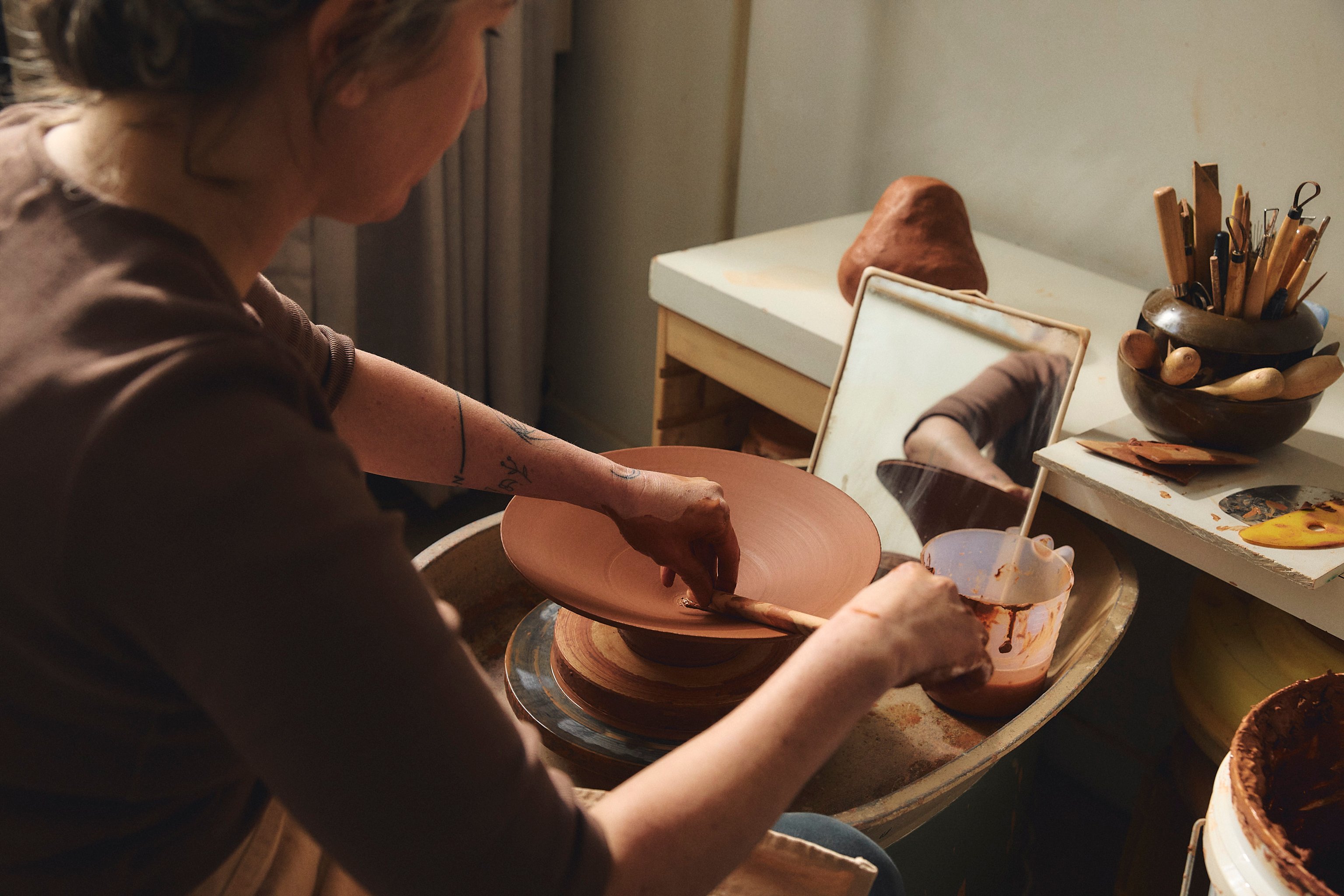 Belinda Wiltshire using her clay wheel for Coco Flip's Dancer Collection.