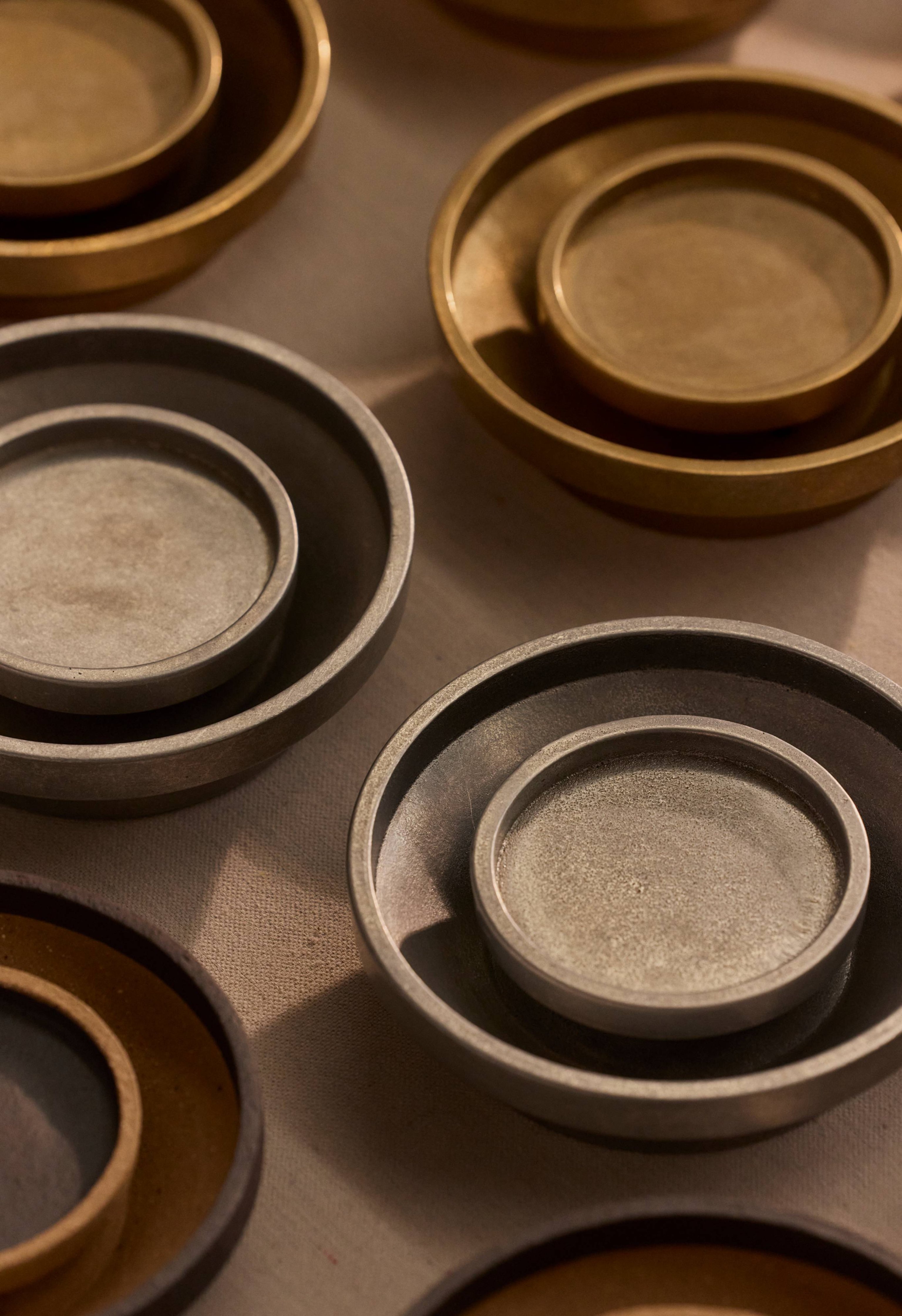 Chorus Wall Lights in Aluminium and Brass, clustered together.