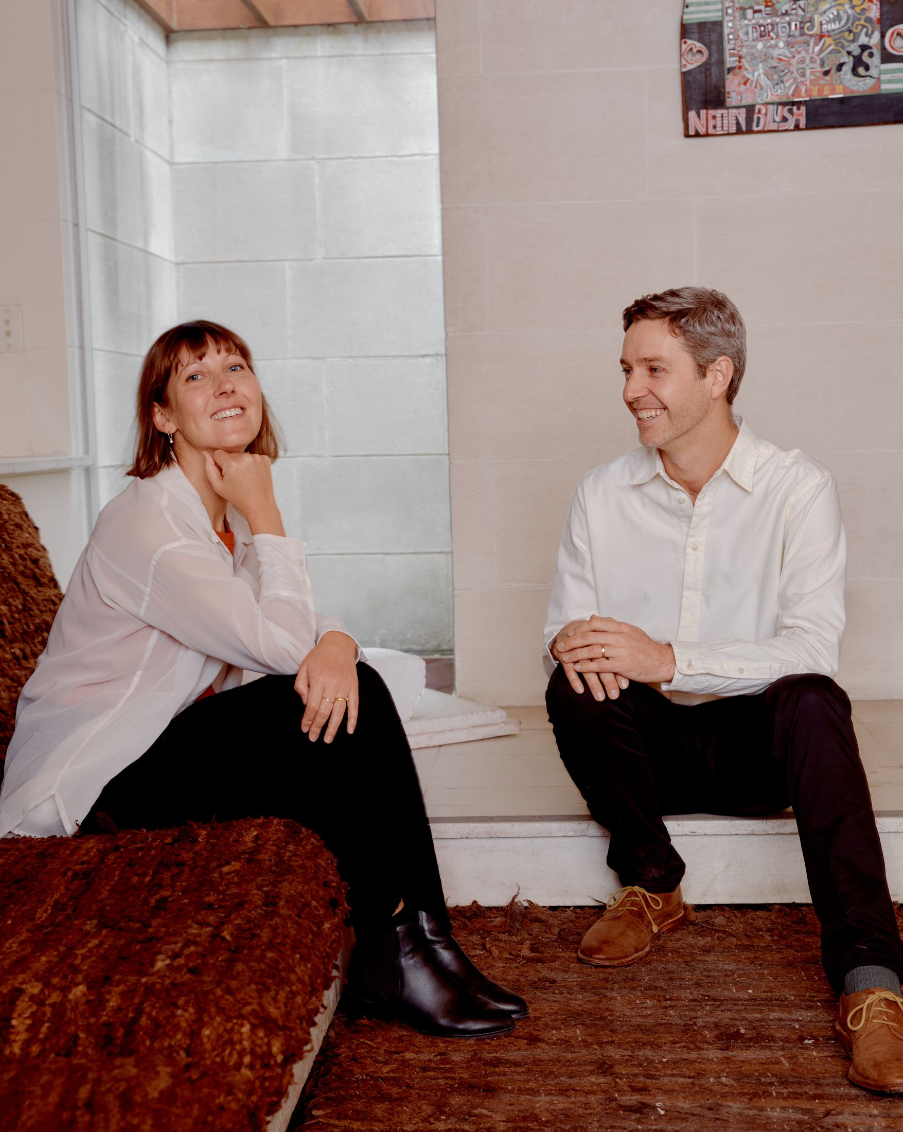 Kate Stokes and Haslett Grounds sitting in the lounge room at Heide Modern.
