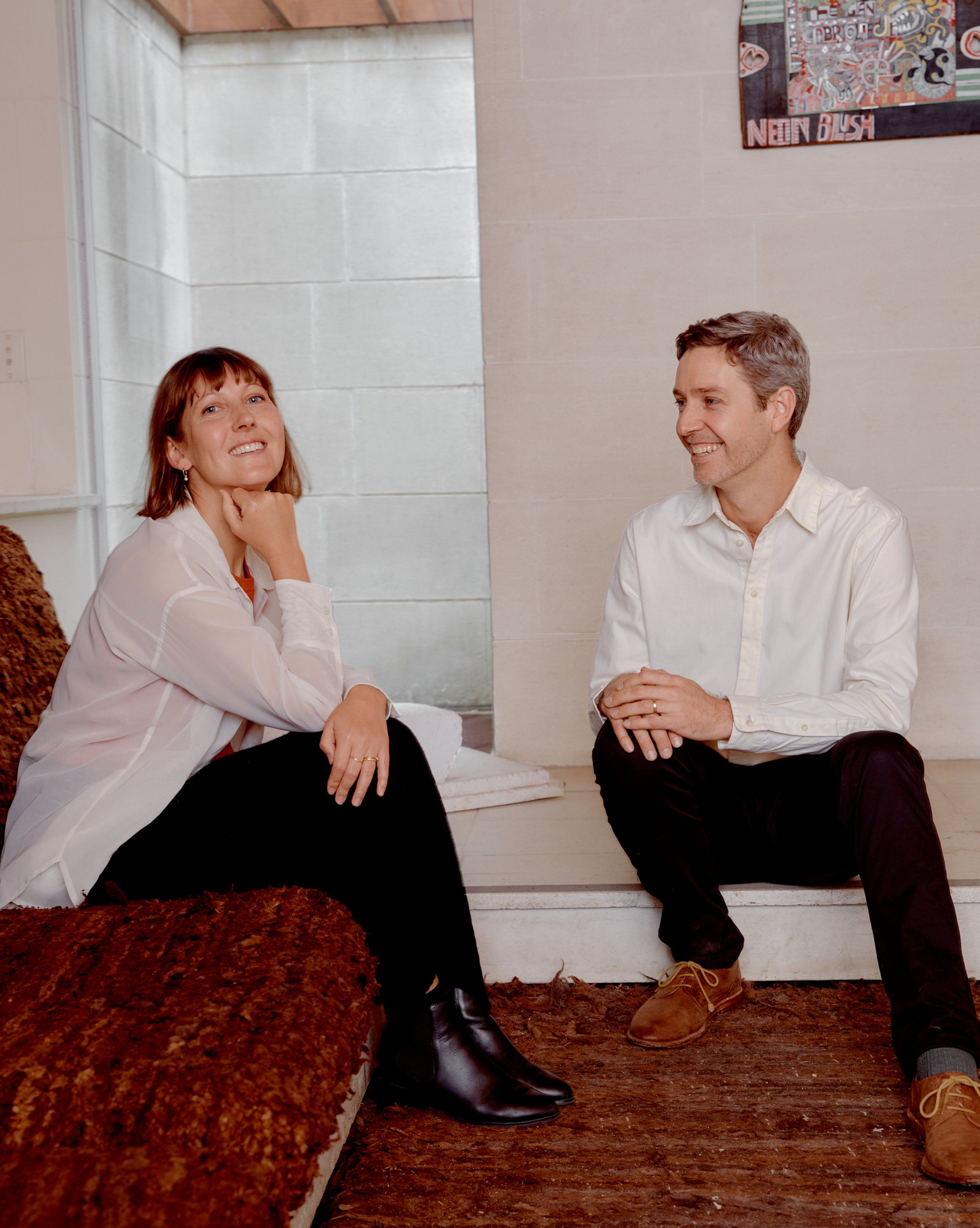 Kate Stokes and Haslett Grounds sitting in the lounge room at Heide Modern.